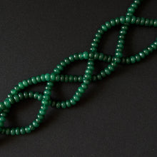 dark Green beads for necklace on a black background. Dyed jade rondelle