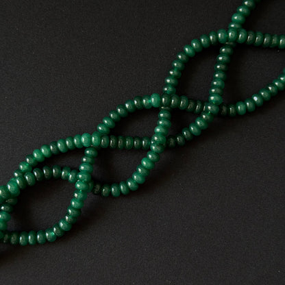 dark Green beads for necklace on a black background. Dyed jade rondelle