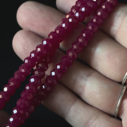 up close video of faceted dark pink or red ruby rondelle beads for necklace