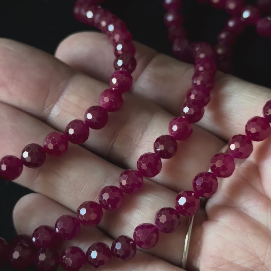 up close video of 3mm facet round beads in ruby